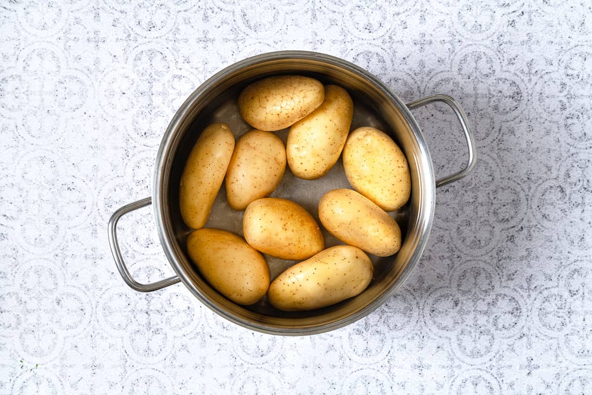 Potatoes boiling in a pot for greek potato salad.