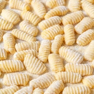 Potato gnocchi that have been dusted with semolina flour to prevent sticking.