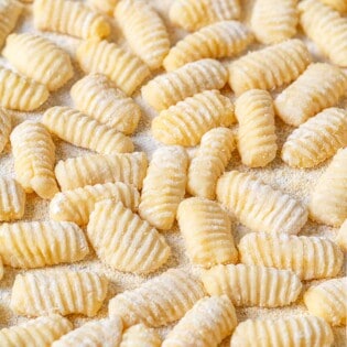 Potato gnocchi that have been dusted with semolina flour to prevent sticking.