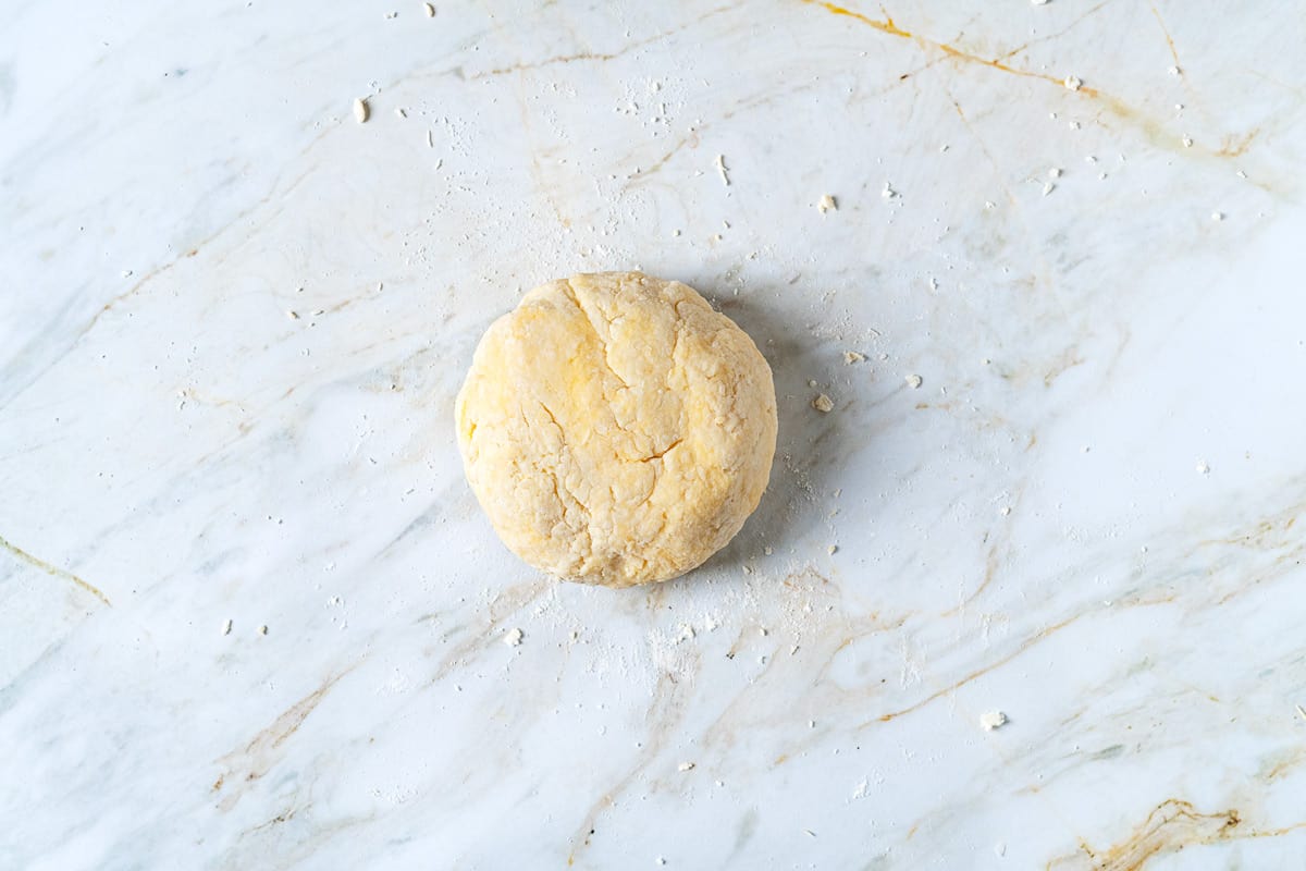 Dough for potato gnocchi that has been shaped into a flat disc.