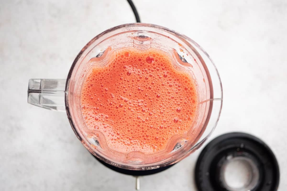 blended strawberries and lemon juice in the pitcher of a blender.