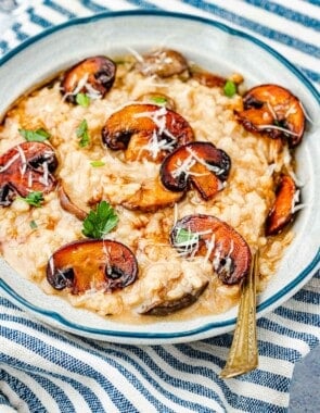 a bowl of mushroom risotto with a spoon.