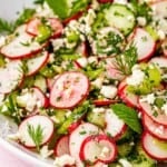 close up of cucumber and radish salad in a bowl.