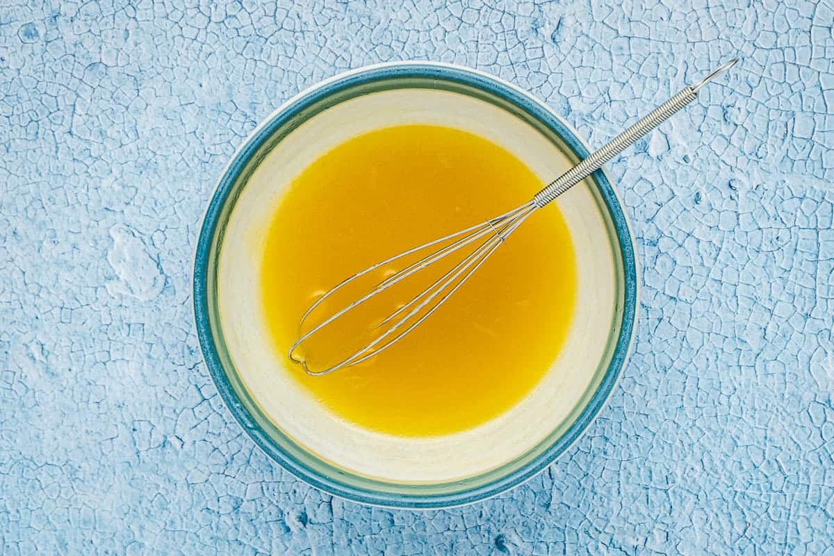 honey lime dressing in a bowl with a whisk.