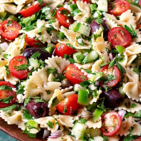 close up of a greek pasta salad in a serving bowl.