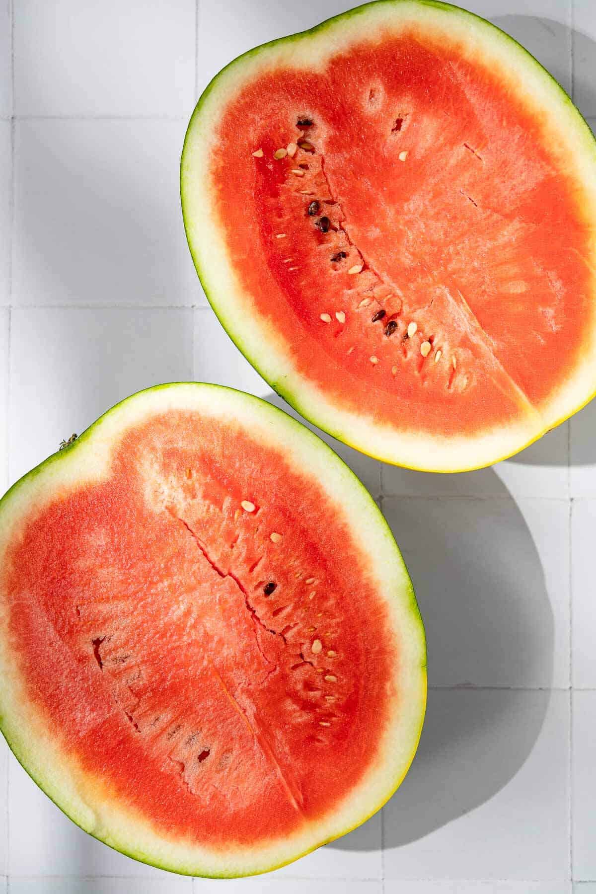 overhead photo of two watermelon halves, flesh up.