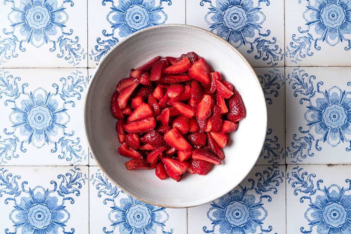 quartered strawberries in a bowl.