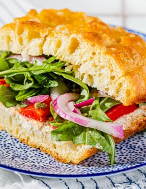 close up of one focaccia sandwich on a plate.