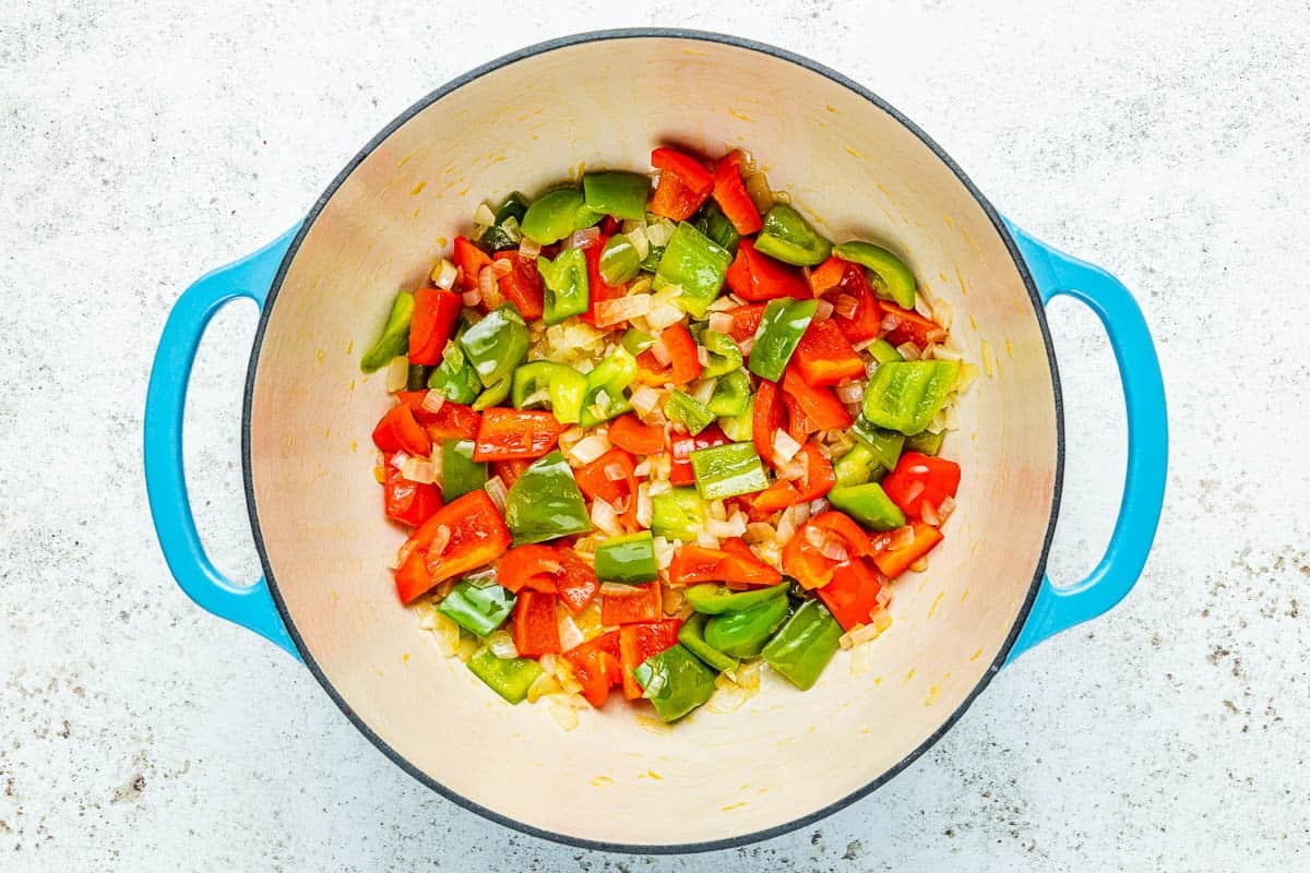 chopped sauteed onions and peppers in a pot.