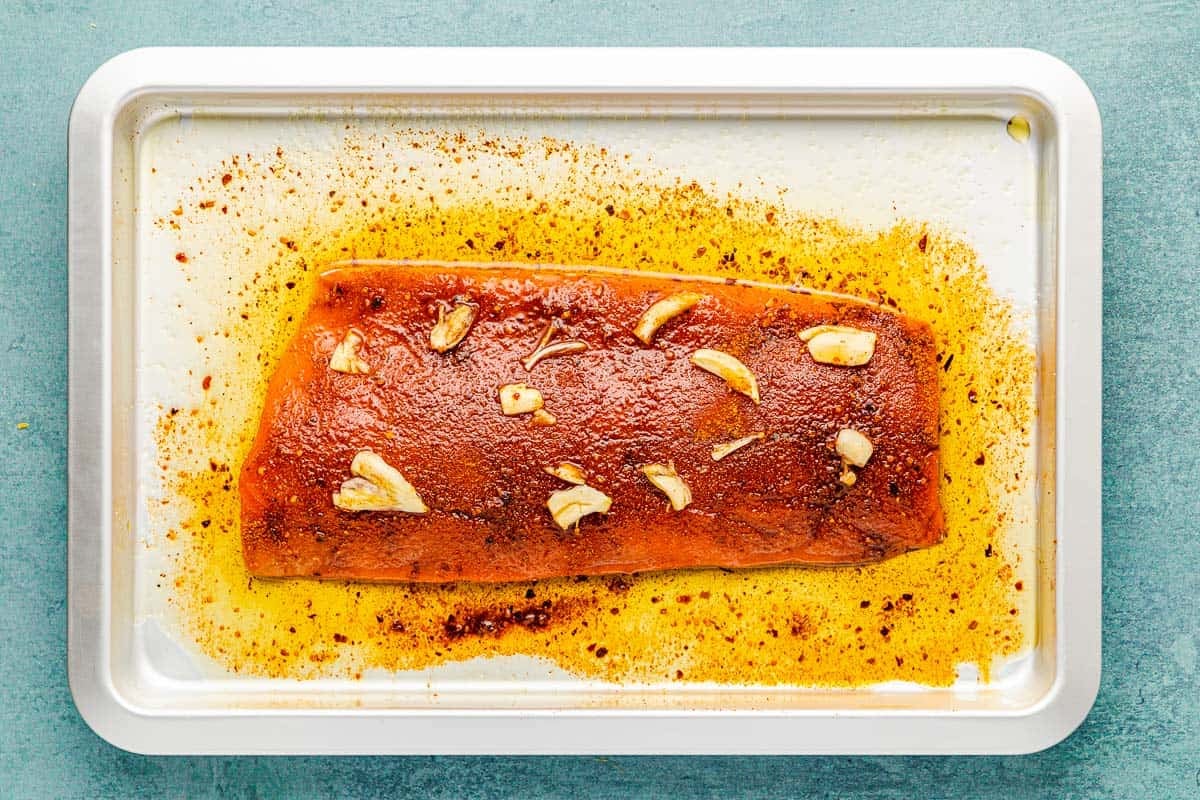 an unbaked salmon filet on an oiled baking sheet.