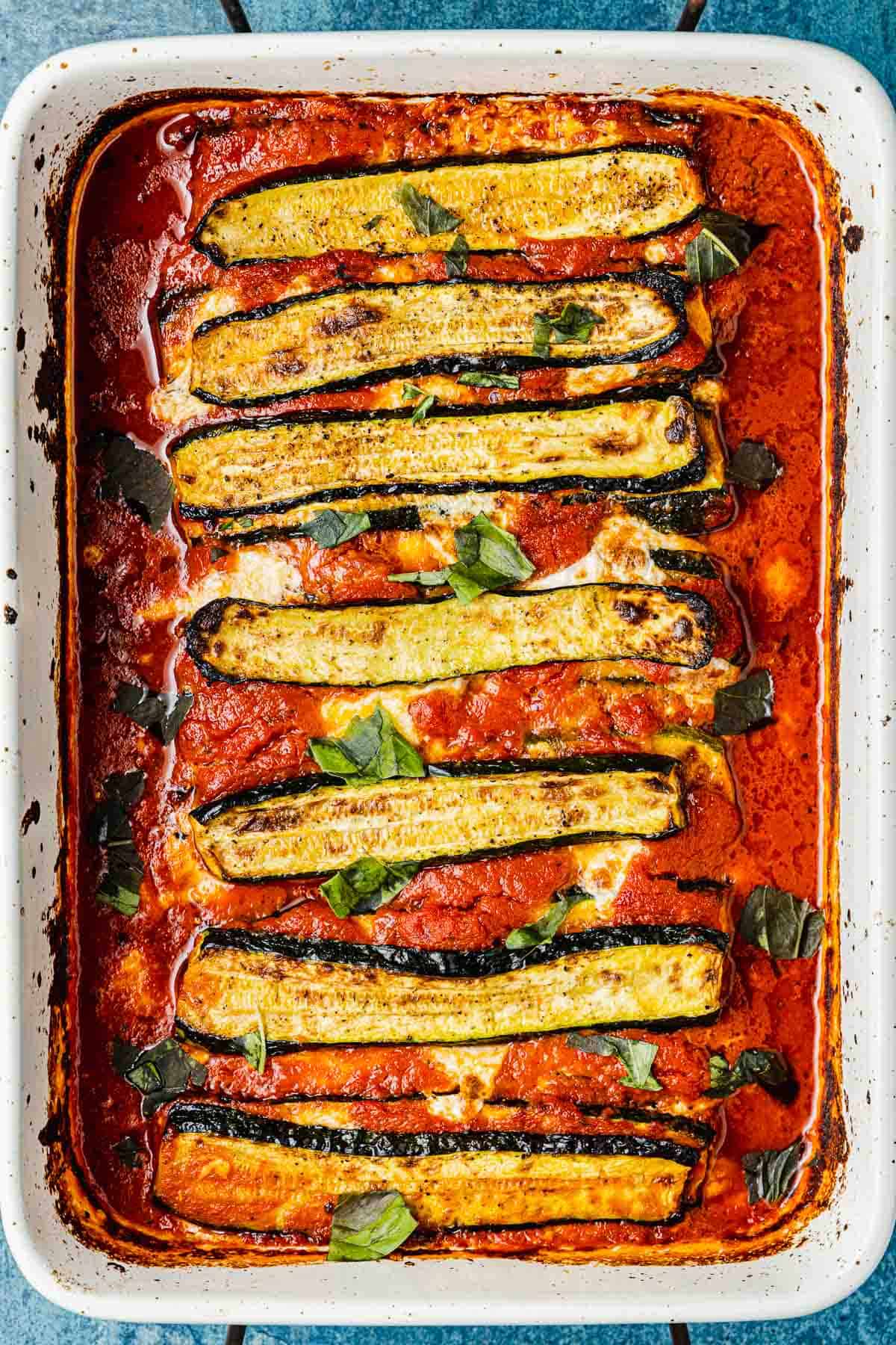 an entire baked zucchini parmesan in a baking dish.