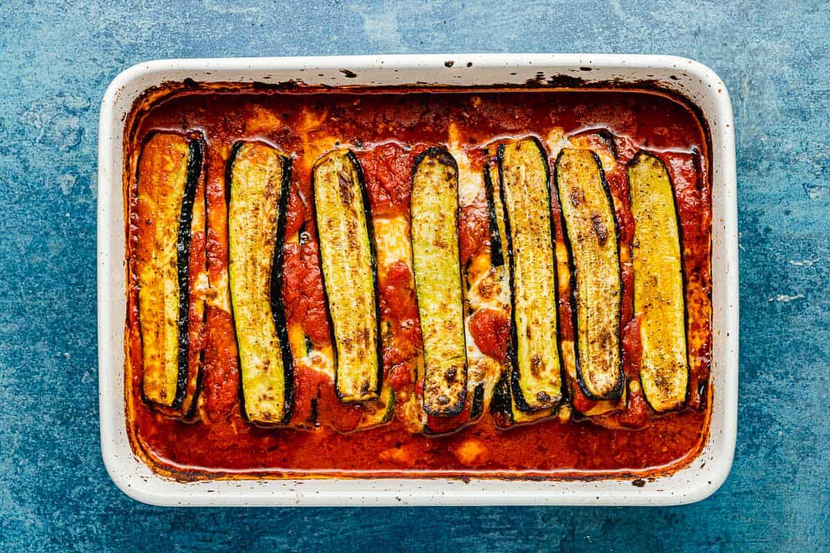 an entire baked zucchini parmesan in a baking dish.