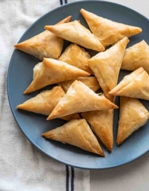 plate full of tiropitakia feta hand pies.