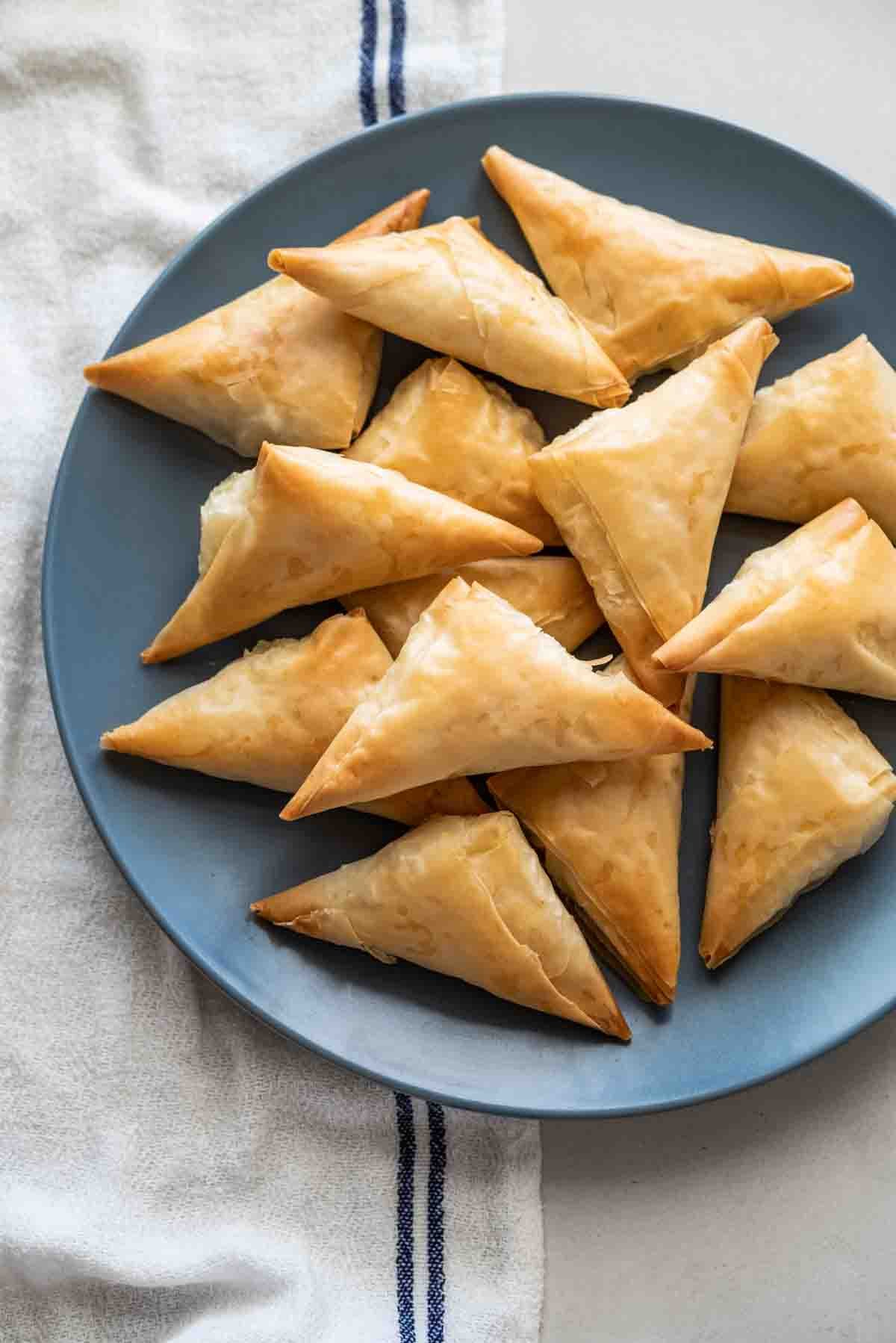 plate full of tiropitakia feta hand pies.