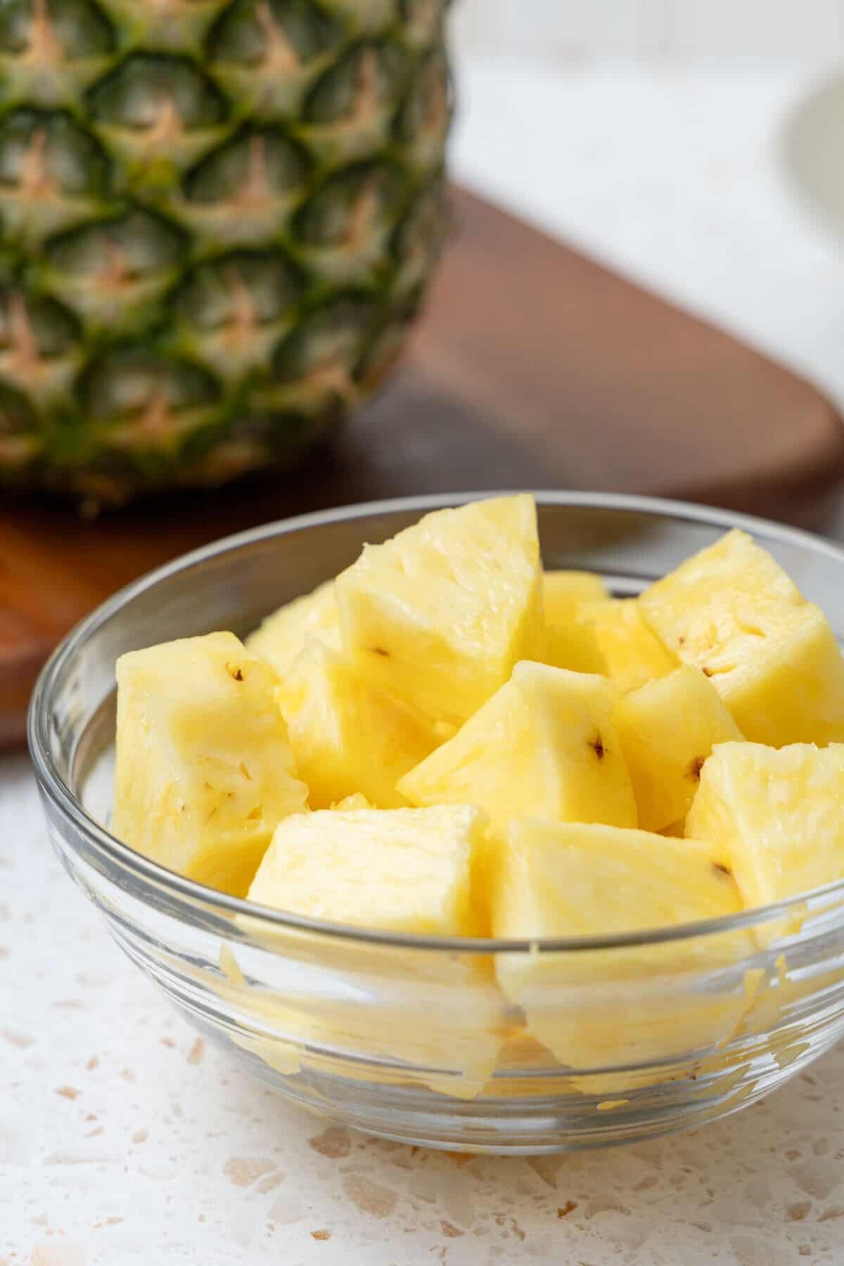 Pineapple slices in a glass bowl.