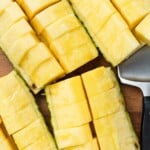 Four sliced pineapple quarters.