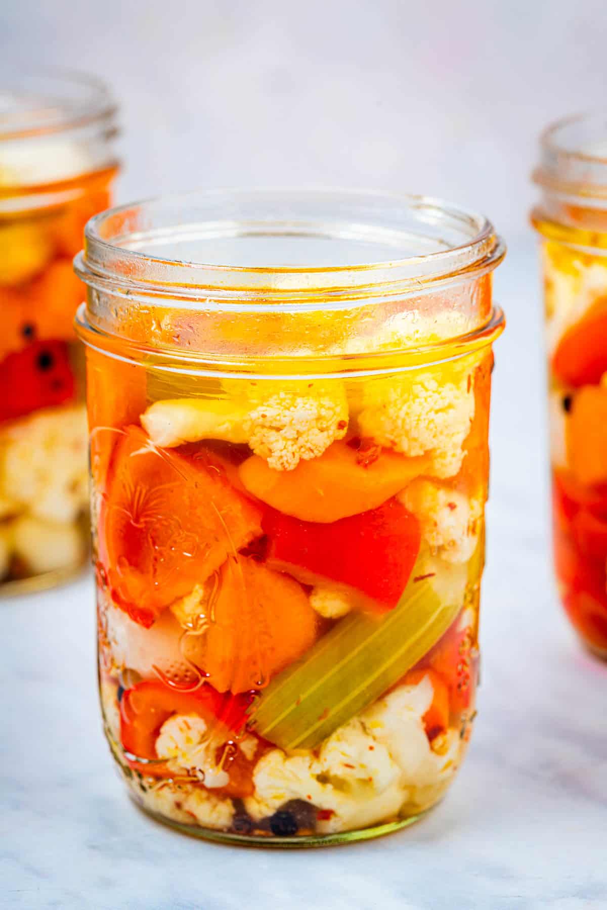 close up of a jar of giardiniera italian pickled vegetables.