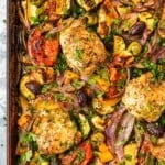 overhead photo of baked Greek sheet pan chicken with vegetables.