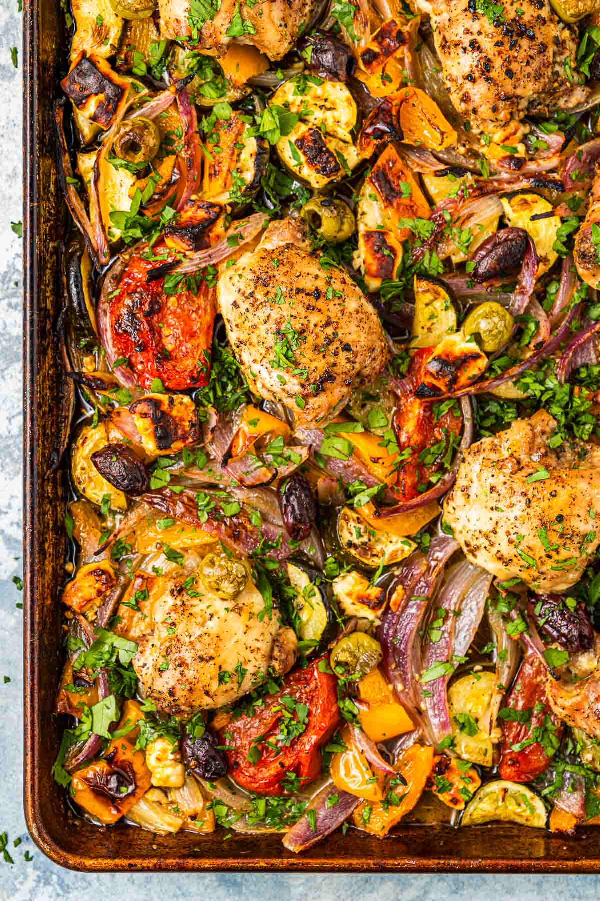 overhead photo of baked Greek sheet pan chicken with vegetables.