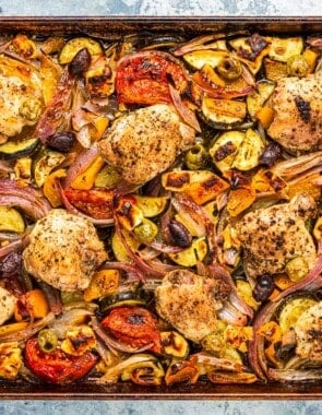 overhead photo of baked Greek sheet pan chicken and vegetables.