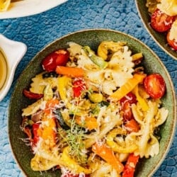 overhead photo of pasta primavera in a green bowl.