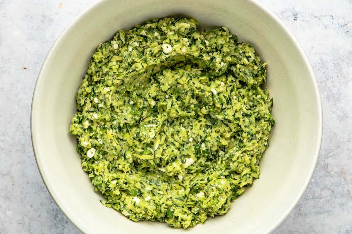 Bowl of zucchini fritter batter in a bowl.