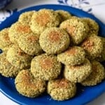a stack of baked falafel on a blue plate.