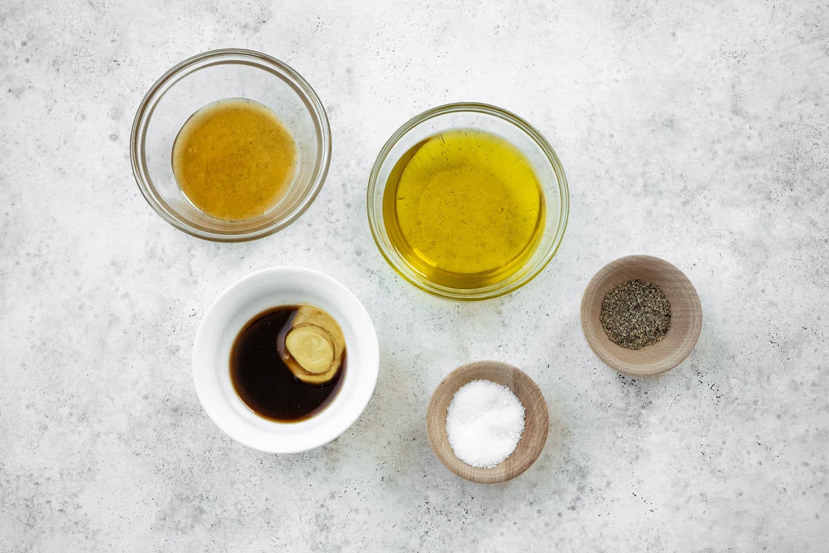 ingredients for honey balsamic vinaigrette including olive oil, dijon mustard, balsamic vinegar, honey, salt and pepper.