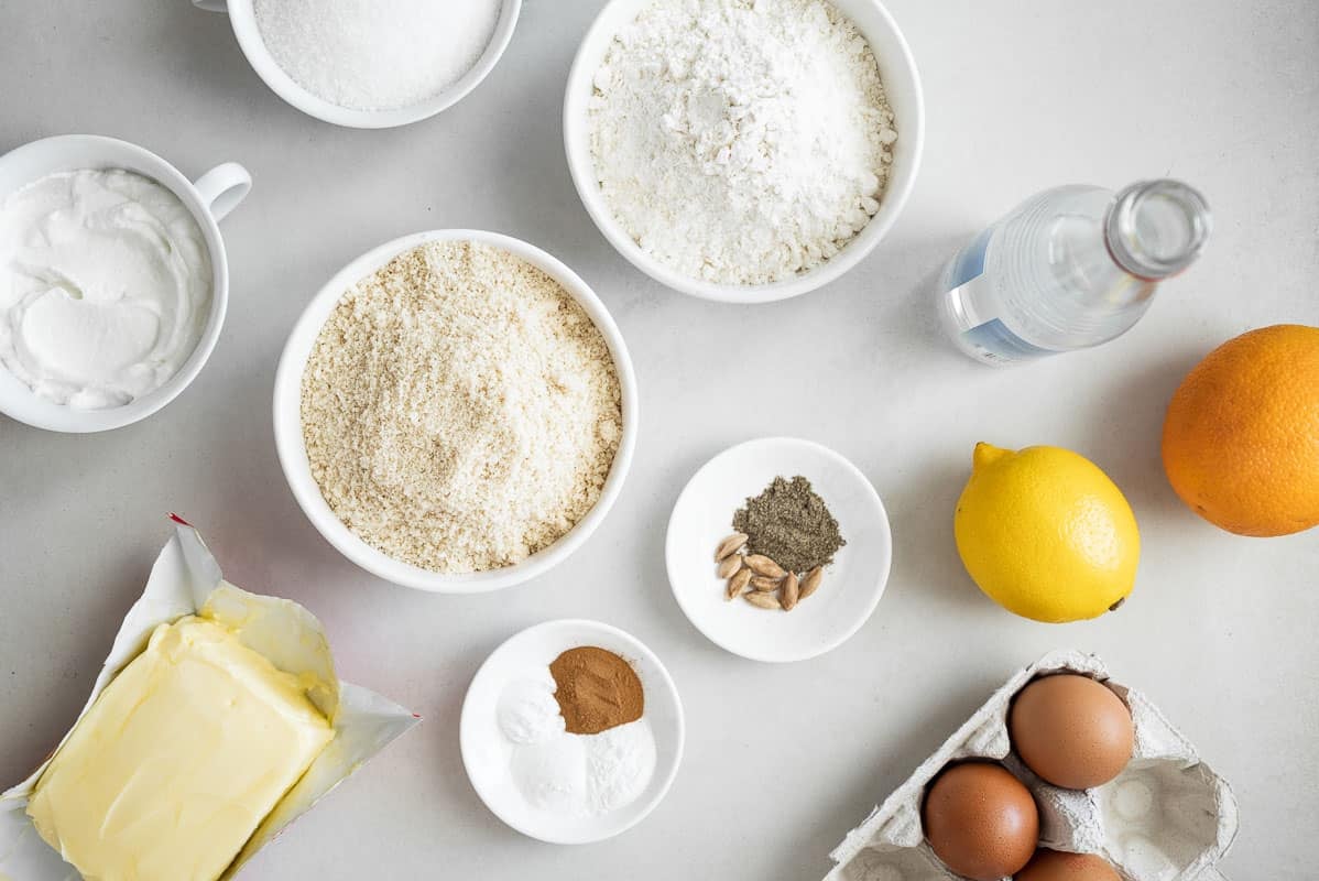 Ingredients for Persian Love Cake, including flour, cardamom, lemon, eggs, orange, and butter.