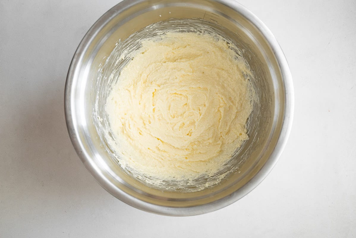 Creamed butter in a metal bowl.