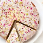 Overhead shot of Persian love cake on a platter with two slices cut out.