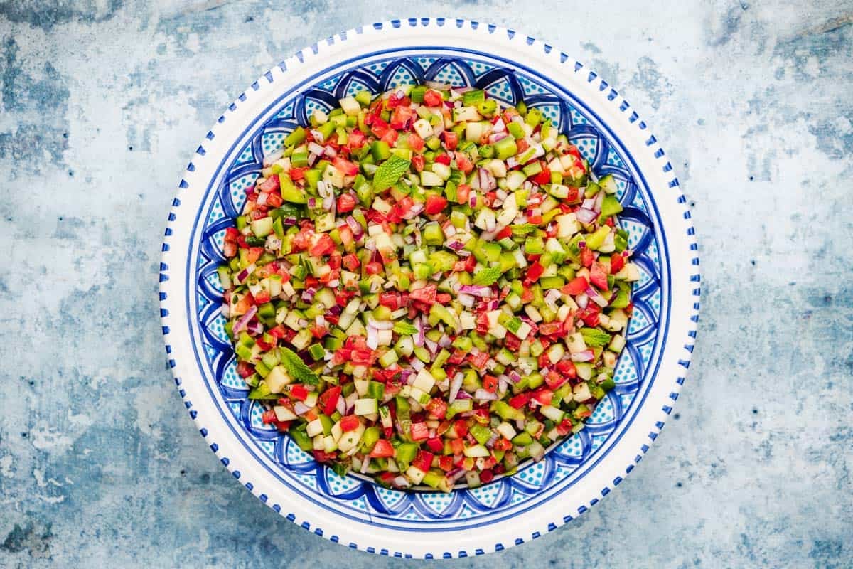 chopped vegetables for Slata Tounsiya Tunisian Salad mixed together in a serving bowl.