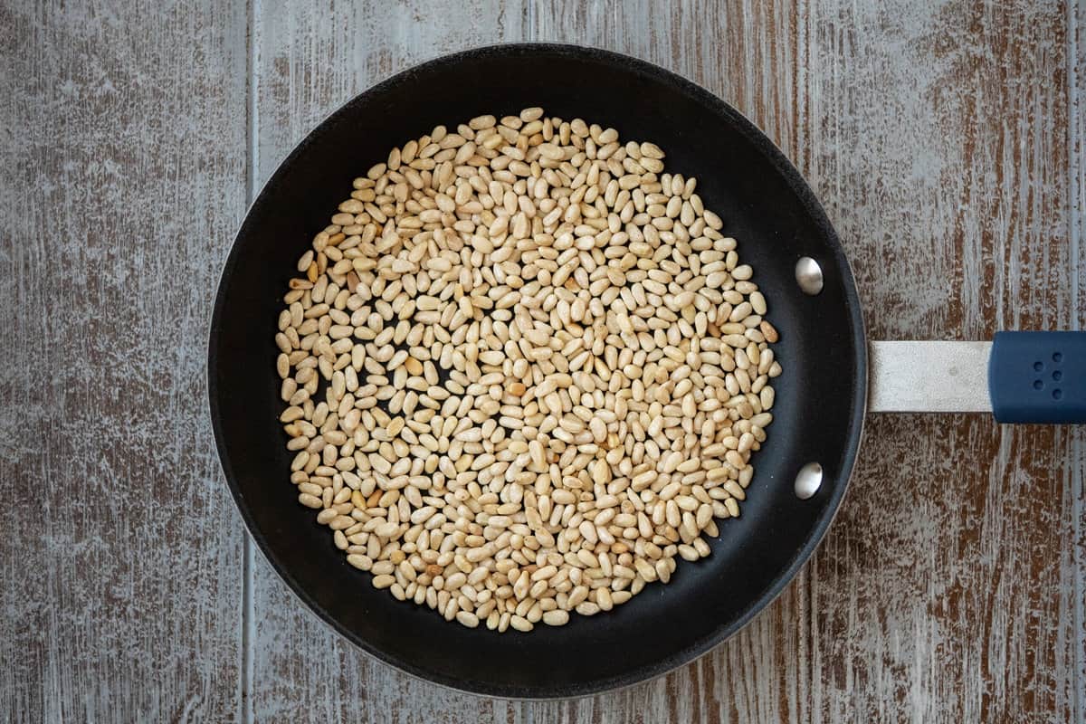 pine nuts toasting in a skillet.