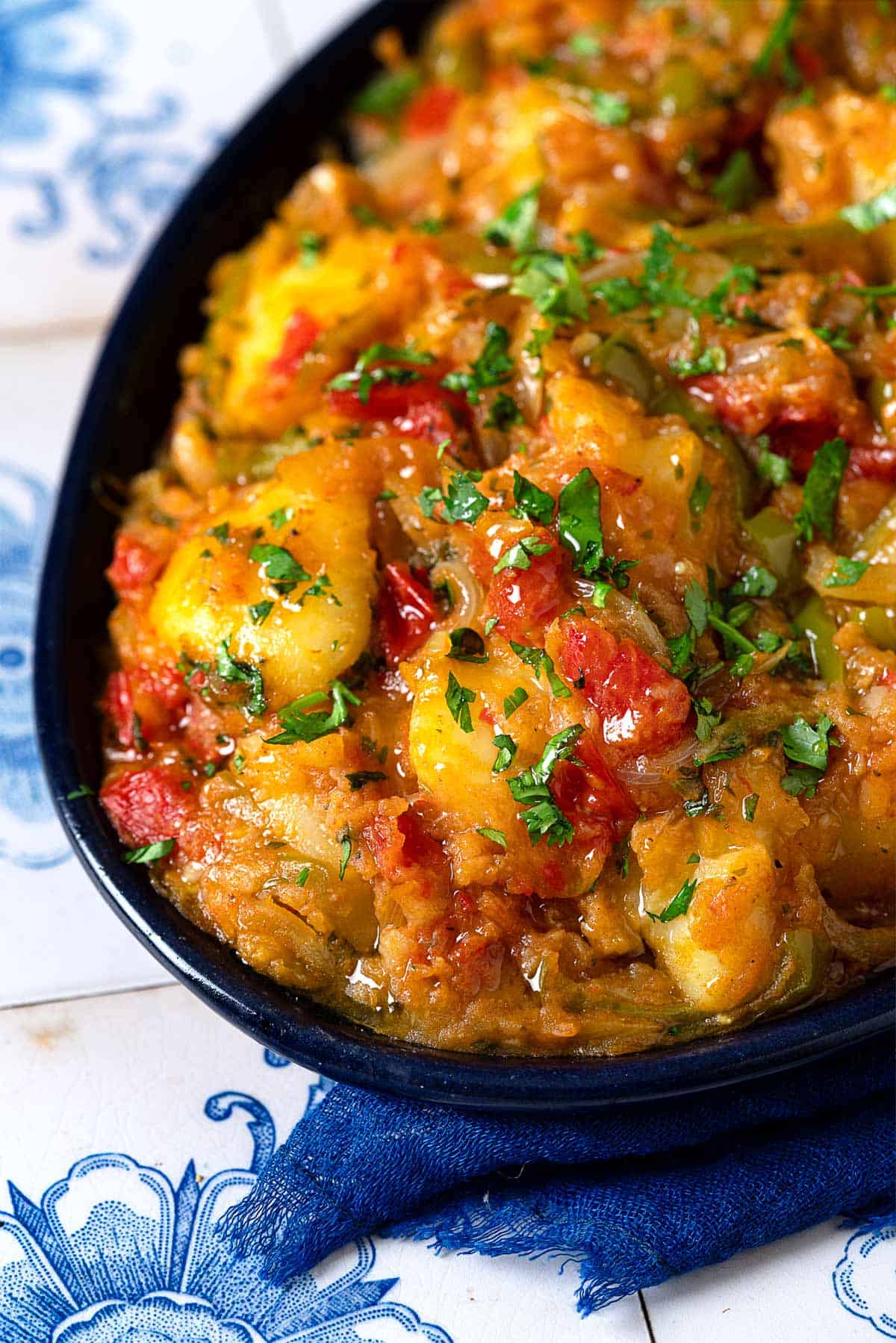 close up of dopiazeh aloo perisan potato curry in a serving bowl.