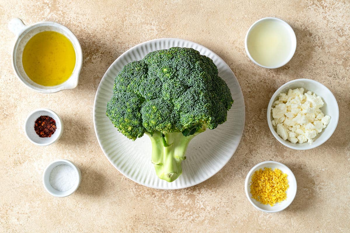 ingredients for roasted broccoli with lemon including broccoli, olive oil, kosher salt, red pepper flakes, feta cheese, lemon juice and lemon zest.