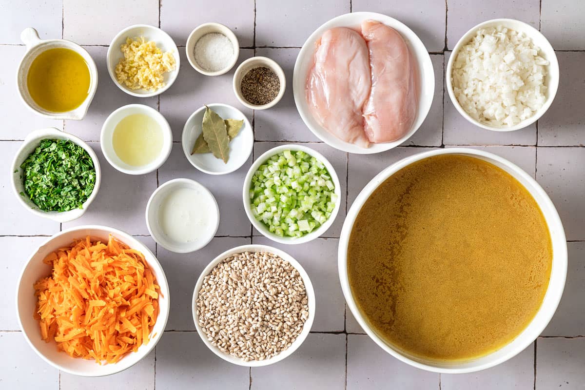 ingredients for soupe jo including chicken, chicken stock, olive oil, onion, garlic, celery, carrot, bay leaves, lemon, half and half, parsley, salt and pepper.