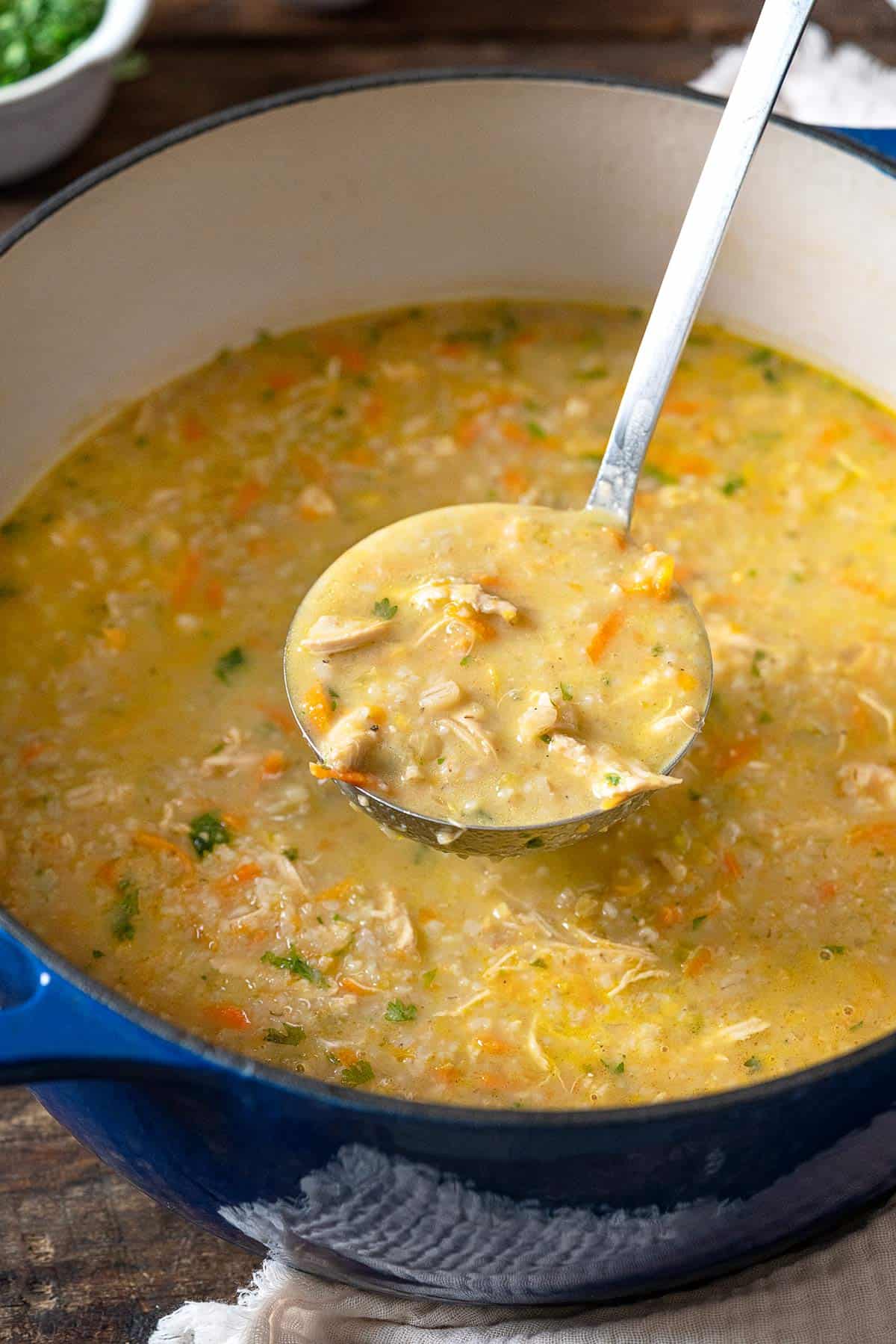 a ladle-full of soupe jo being lifted from a pot.