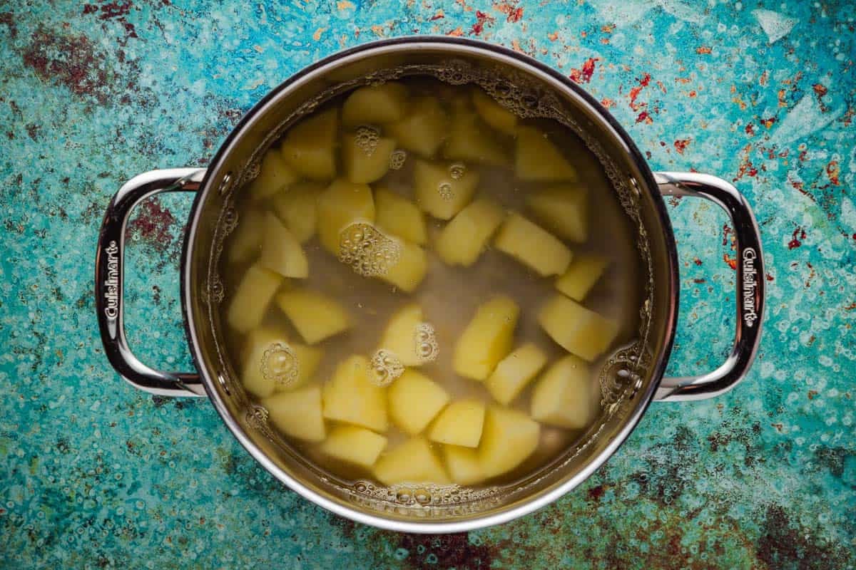 potato pieces boiling in a pot.