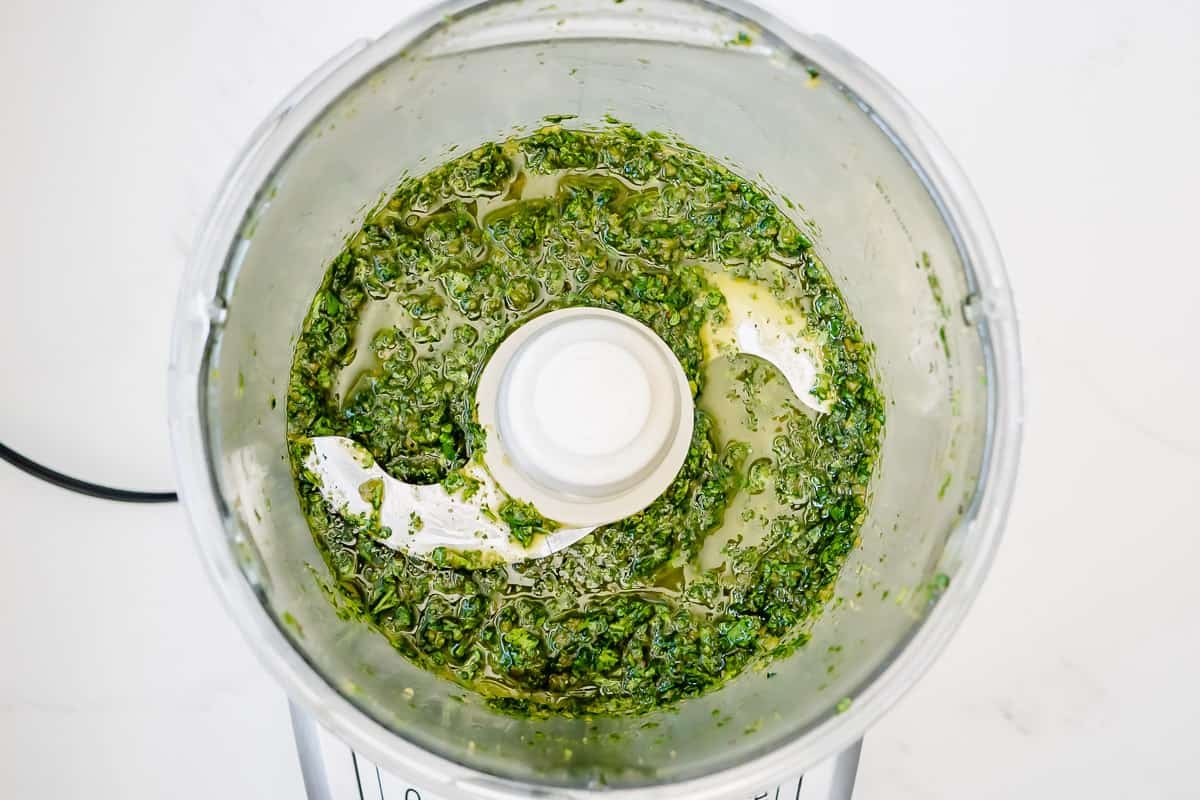 Food processor with Chermoula that has been blended, showing the slightly chunky texture.