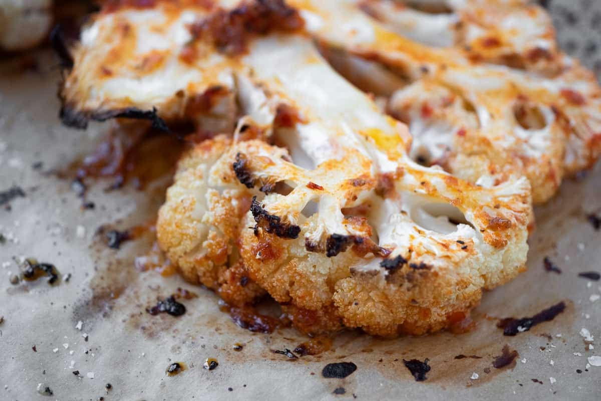 Close up of a roasted cauliflower steak, showing the charred edges.