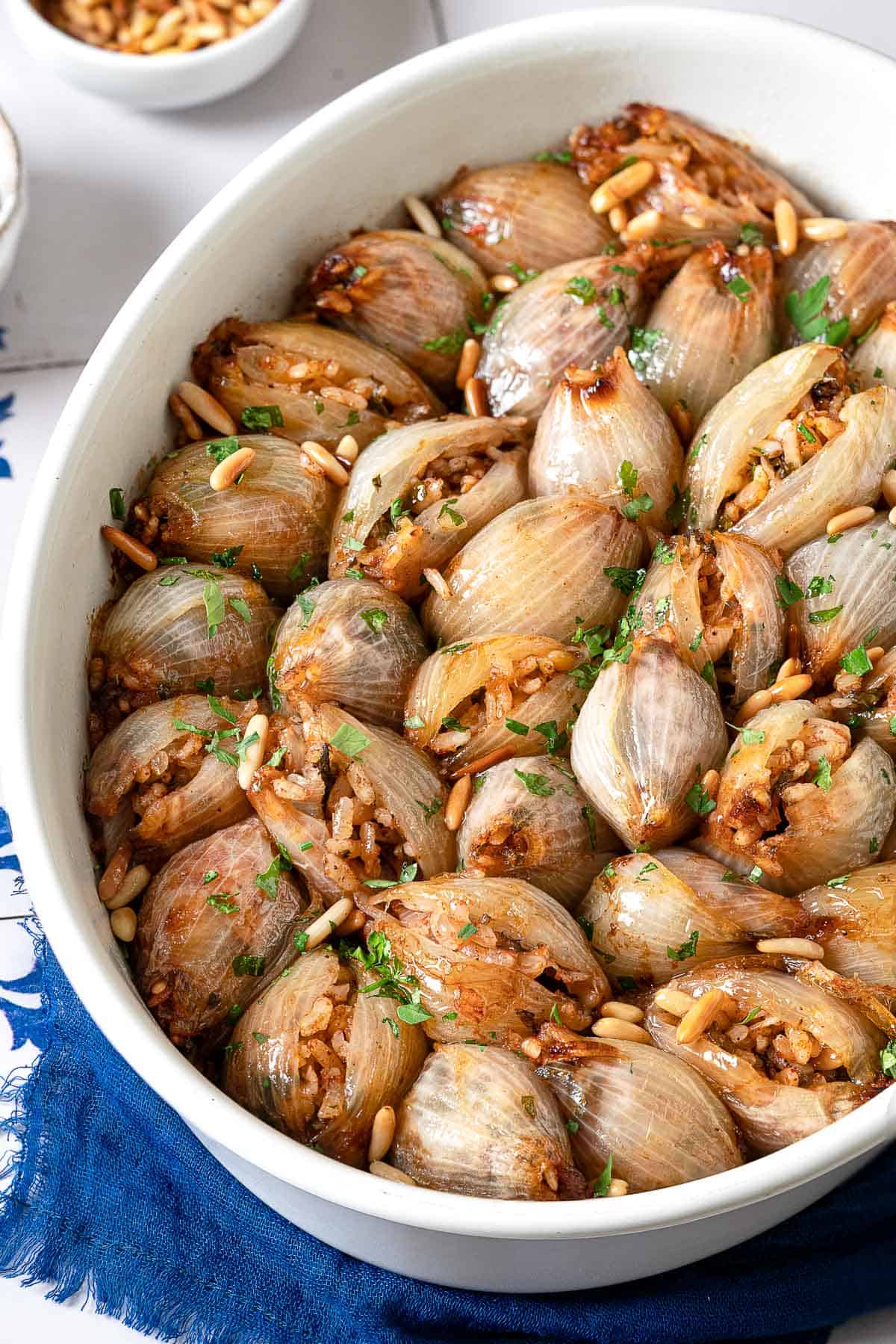 overhead photo of stuffed onions in a white serving bowl. 