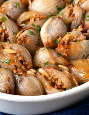 a close up of stuffed onions in a serving bowl.
