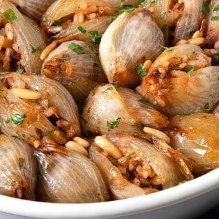 a close up of stuffed onions in a serving bowl.