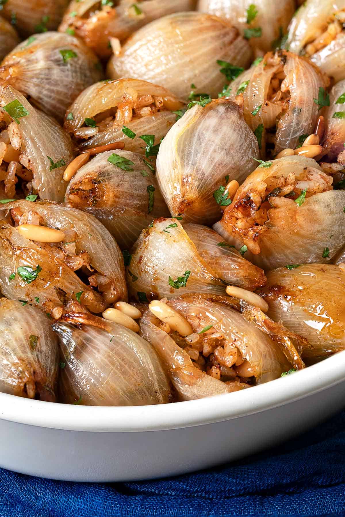 a close up of stuffed onions in a serving bowl. 