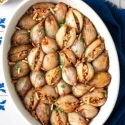 overhead photo of stuffed onions in a white serving bowl.