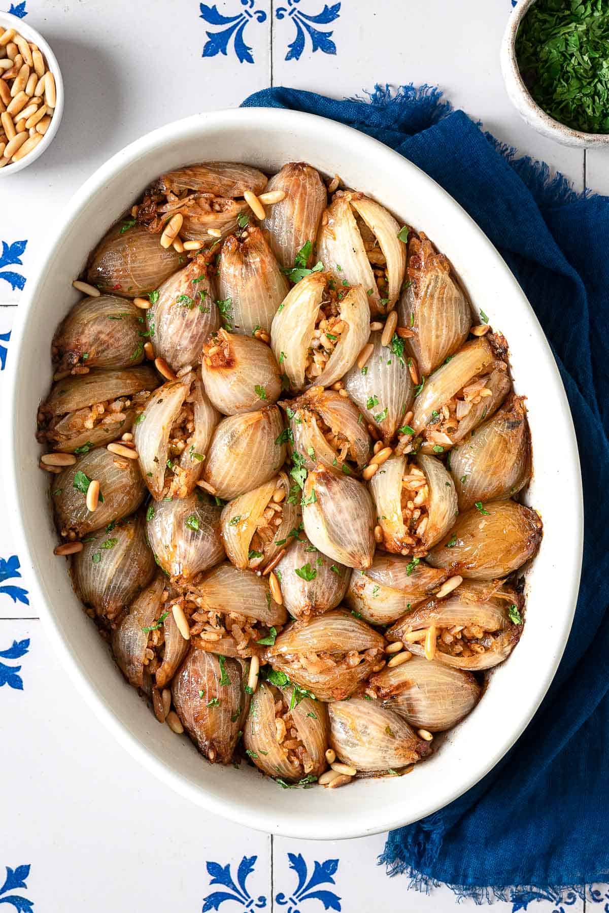 overhead photo of stuffed onions in a white serving bowl.