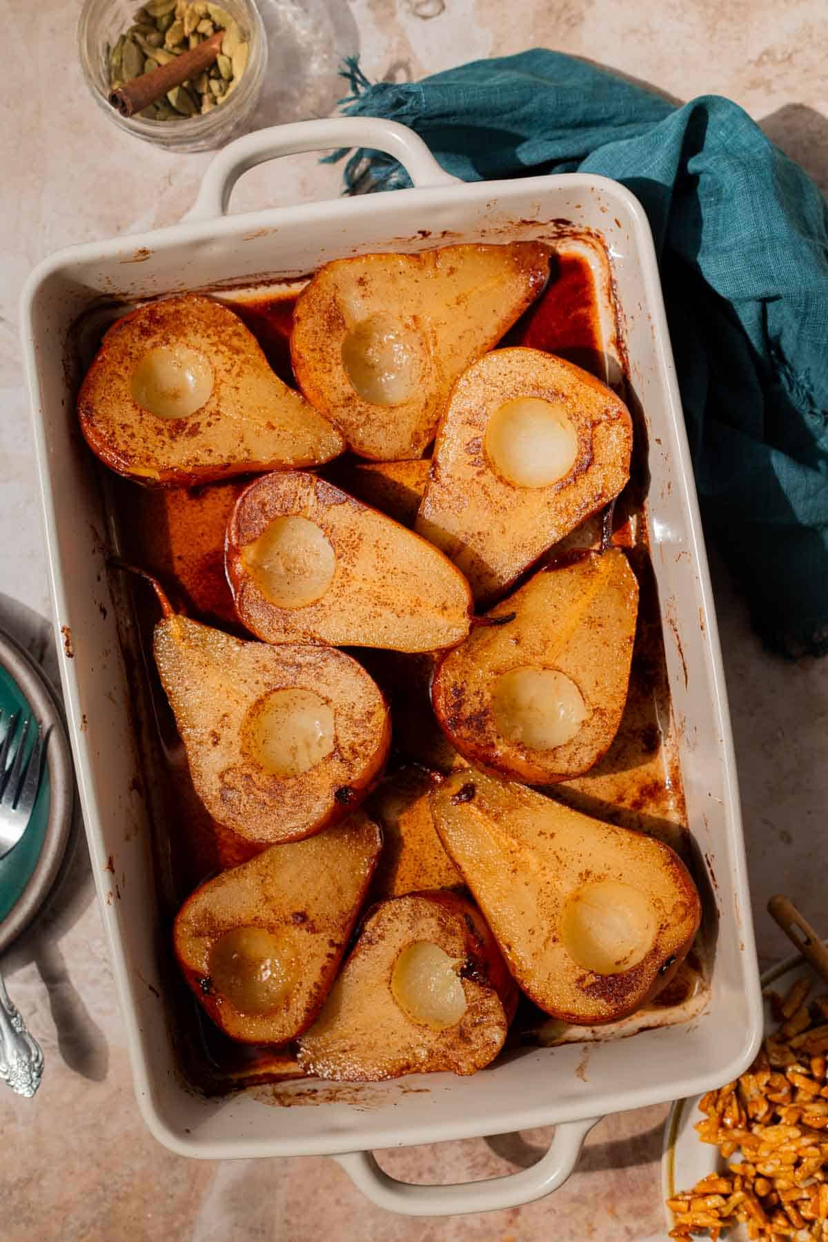 Overhead shot of baked pears in a white baking dish.