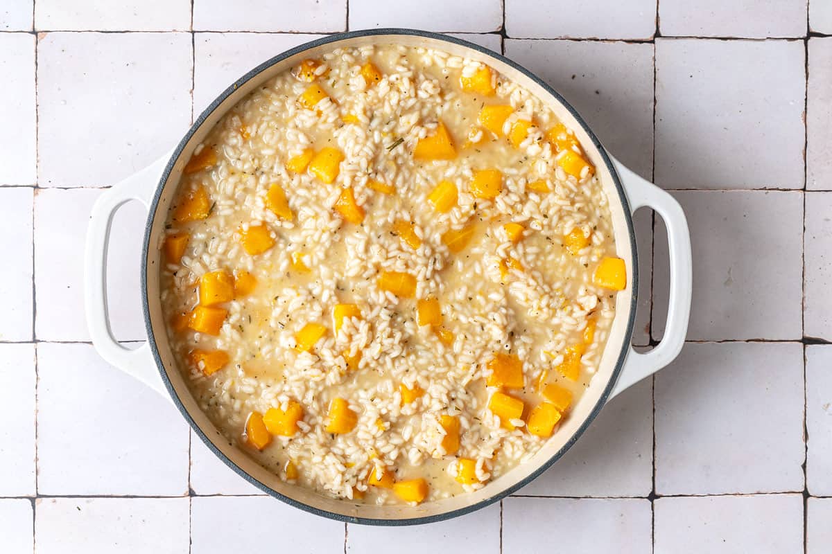 butternut squash risotto cooking in a pot.