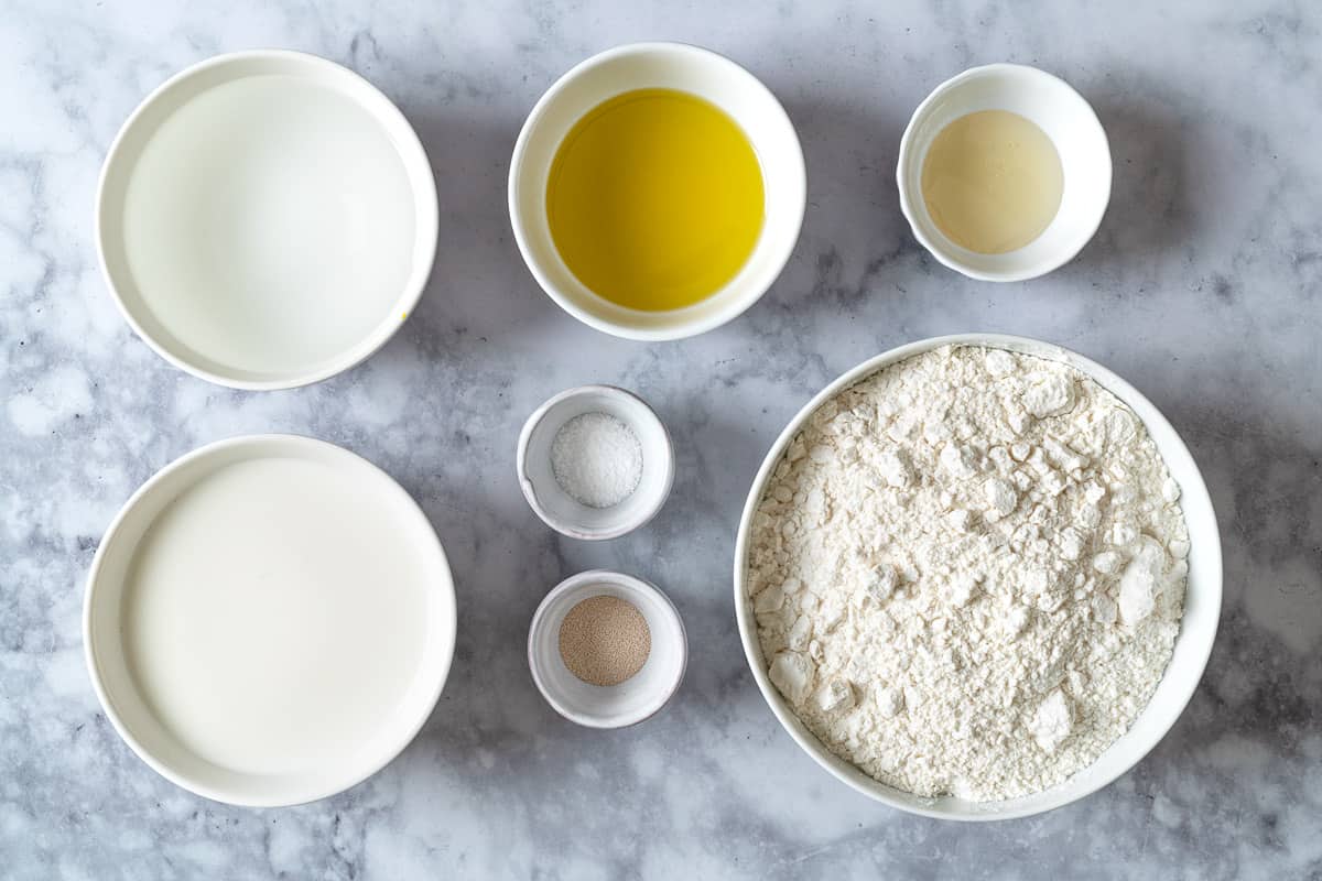 Ingredients for lavash bread, including bread flour, instant yeast, salt, water, milk, honey, and olive oil.