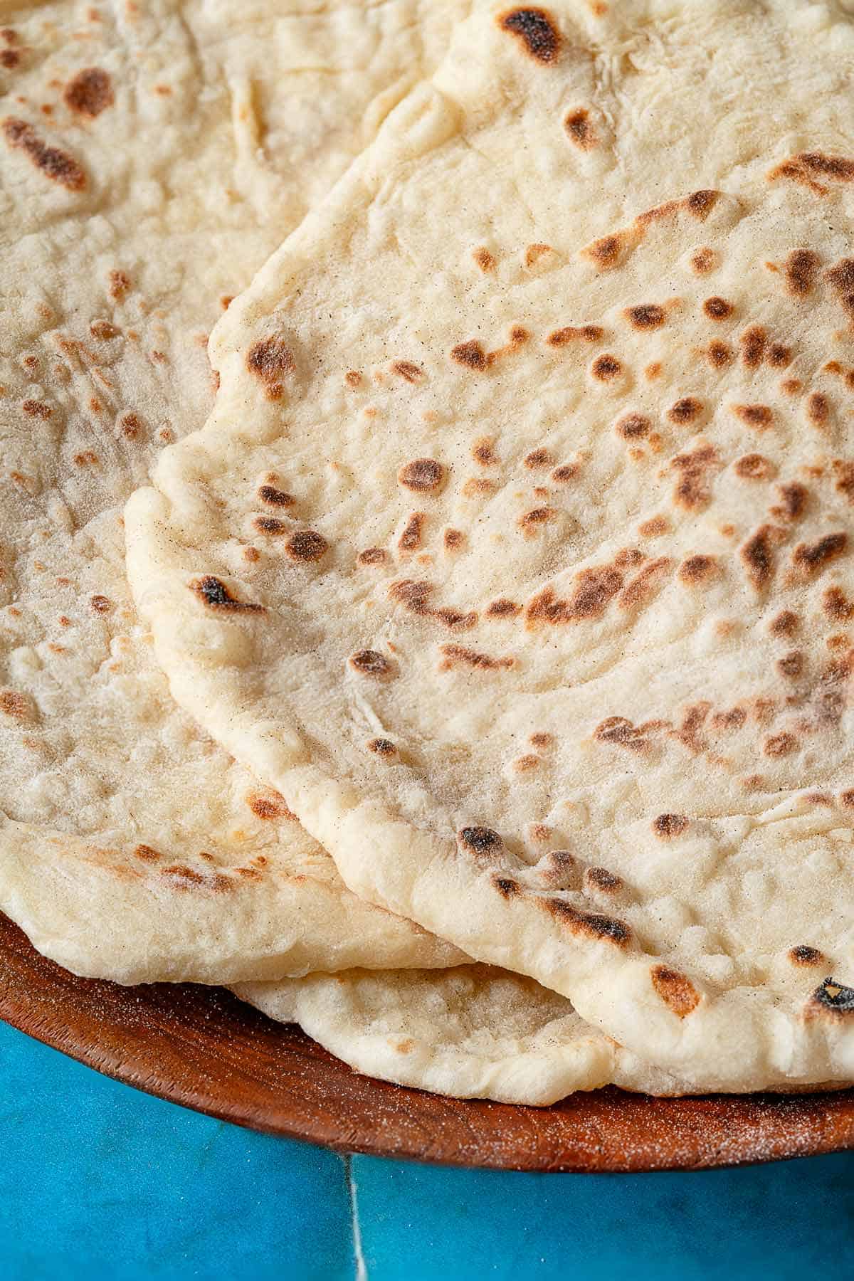 Close up of lavash bread, showing the golden brown spots where it hit the pan.